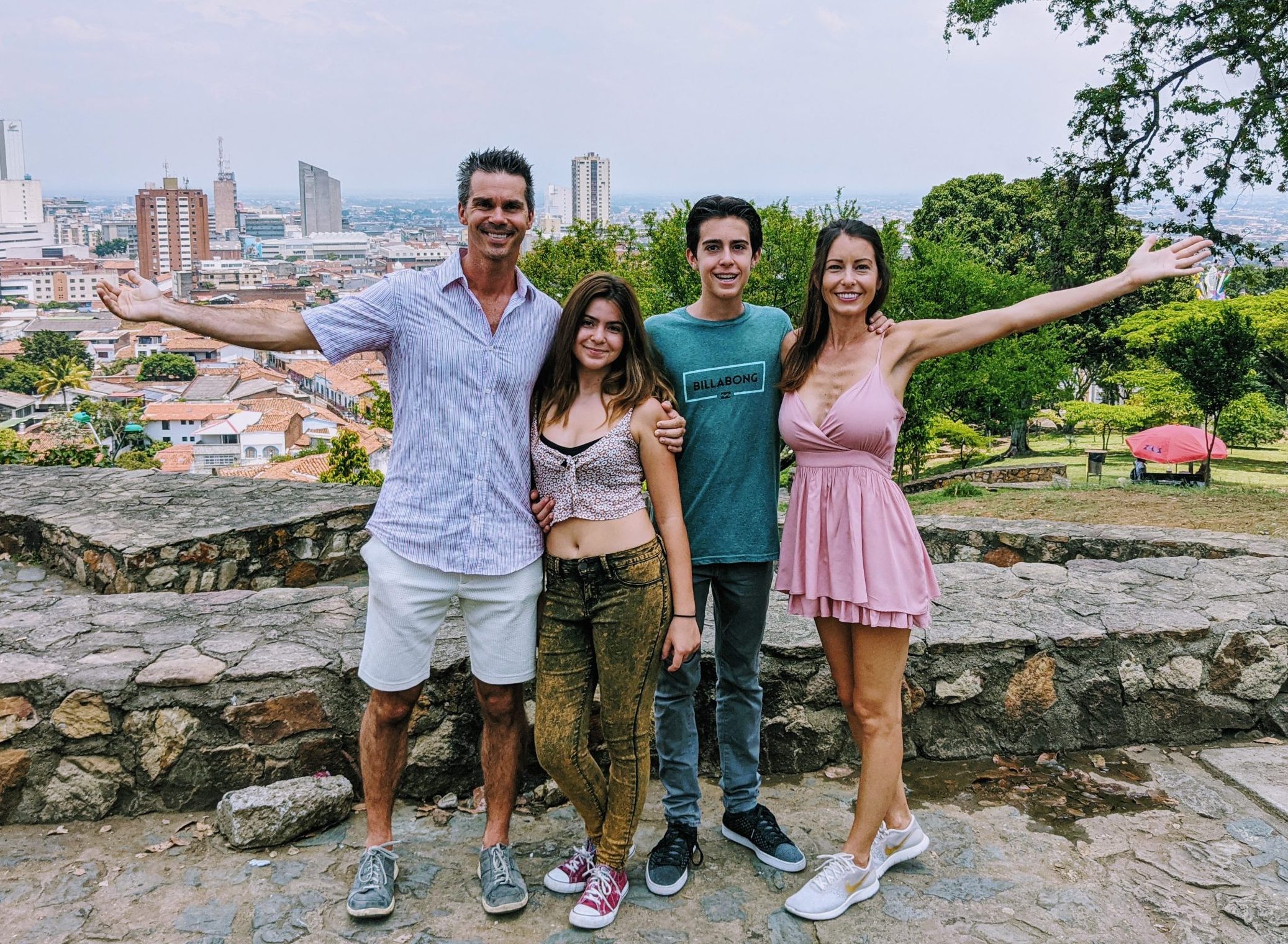 Zingg family stand in front of a view overlooking Medellin, Colombia